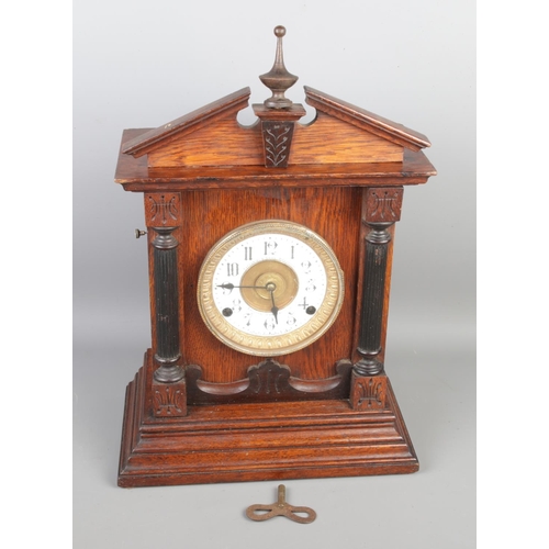 98 - A vintage Fattorini & Sons Bradford alarm mantel clock, with its original pendulum and key, height 4... 