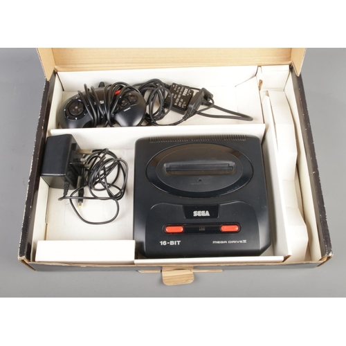 253 - A Sega Mega Drive II console, in Sonic 3 sleeve, together with a collection of gaming cartridges and... 