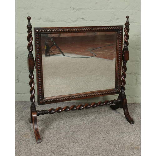 297 - An early 20th century oak dressing table mirror with barley twist supports.