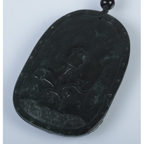 355 - A black jade pendant featuring an adjustable necklace cord, crafted from Burma Type A jade. The pend... 