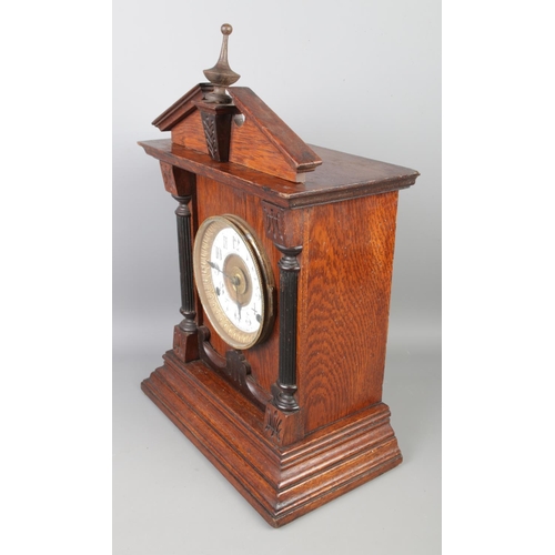 98 - A vintage Fattorini & Sons Bradford alarm mantel clock, with its original pendulum and key, height 4... 