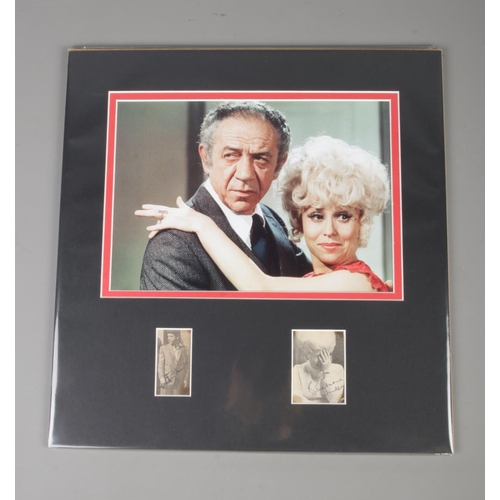 164 - A mounted and signed film still from 'Carry On Girls' featuring Sid James and Barbara Windsor, each ... 