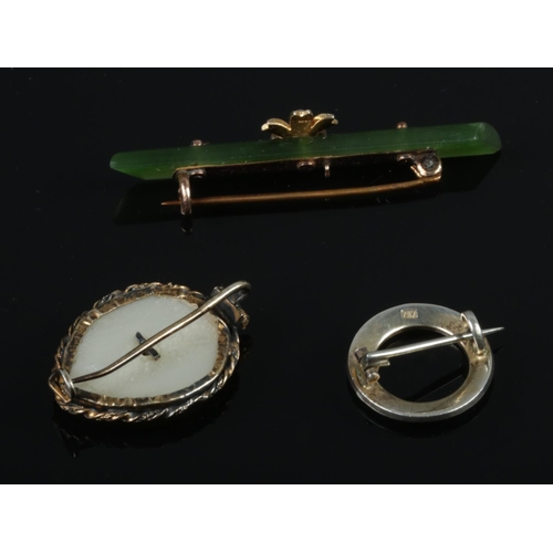 379 - Three brooches including a 9ct gold mounted Nephrite example, mother of pearl example and Turquoise ... 