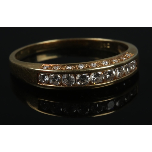 384 - An 18ct gold 9 stone channel set diamond ring with smaller rows set either side.

3.3g