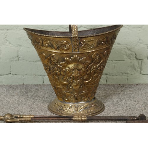 262 - A brass embossed coal scuttle with tongs and shovel etc