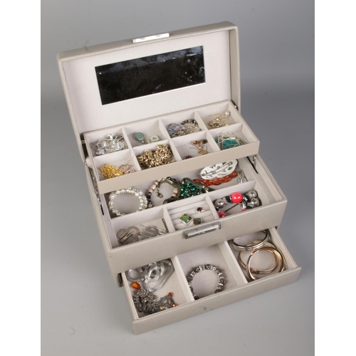 108 - A faux leather cantilever jewellery box with contents of assorted costume jewellery to include silve... 