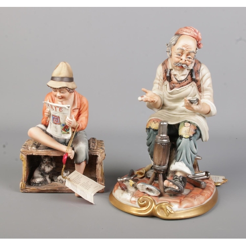 112 - Two Capodimonte ceramic figures to include cobbler and young boy reading 'Arte' newspaper. Both with... 