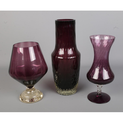 114 - Three purple coloured glass vases to include Whitefriars style example and one featuring bubble incl... 