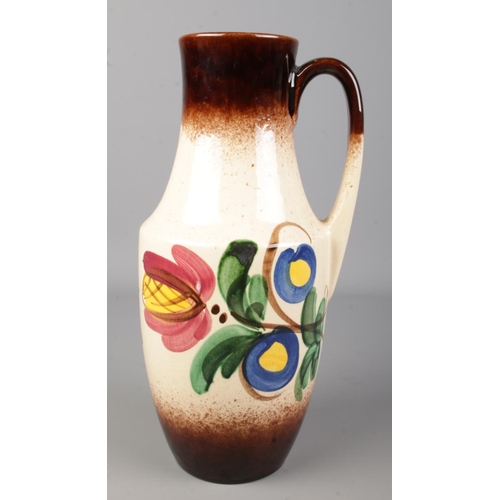 117 - A West German pottery handled vase. With painted floral decoration. Height 35cm.