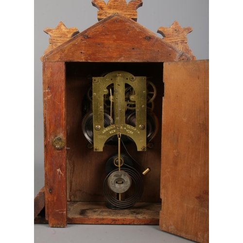 128 - An early Twentieth Century oak cased Ansonia mantle clock, with carved detailing and twin spindle pi... 