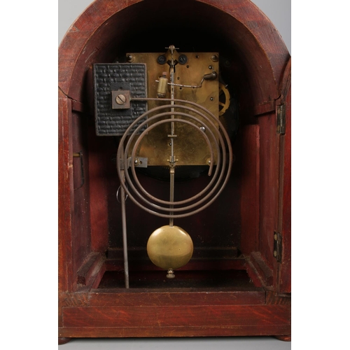 135 - A mahogany and inlaid arched top Badische Uhrenfabrik mantle clock, with central urn patera. Featuri... 