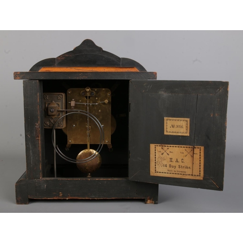 137 - An ebonised wooden Hamburg American Clock Co. (HAC) mantle clock, No. 3056. The dial bearing Roman N... 