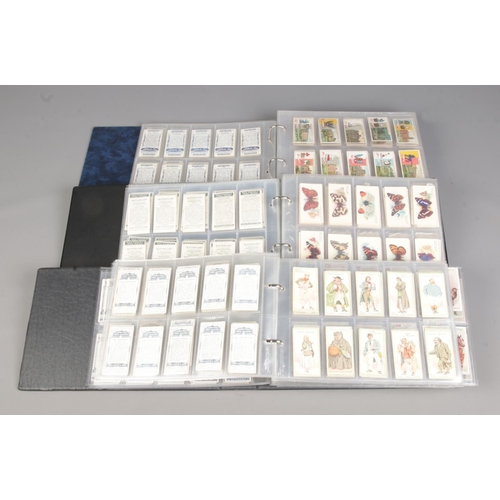 160 - Three albums featuring themed sets of vintage cigarette cards, along with a bag of loose cards. Prim... 