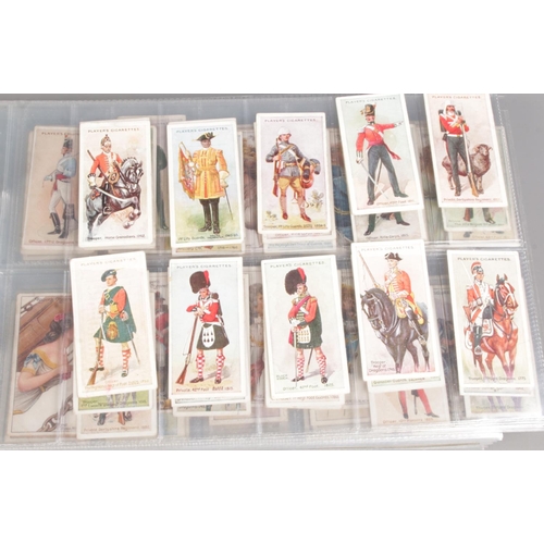 160 - Three albums featuring themed sets of vintage cigarette cards, along with a bag of loose cards. Prim... 