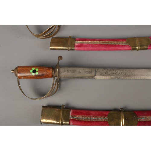 23 - Two vintage Indian cavalry dress swords both in velvet wrapped scabbards with etched blade and flora... 