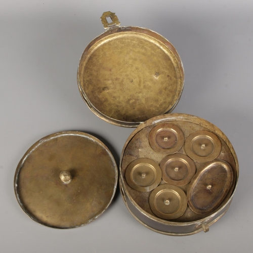 28 - An Indian brass spice box/masala dabba of circular form featuring six individually lidded compartmen... 