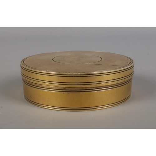 32 - A reproduction circular compass and sundial, housed in brass case.