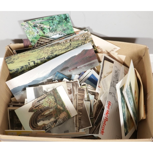 266 - A box of vintage postcards, including both used with stamps and unused, featuring various themes and... 