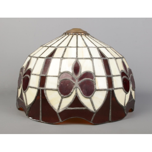 33 - A Tiffany style lamp shade, with cream and deep red panels separated by lead lining. Diameter: 37cm.