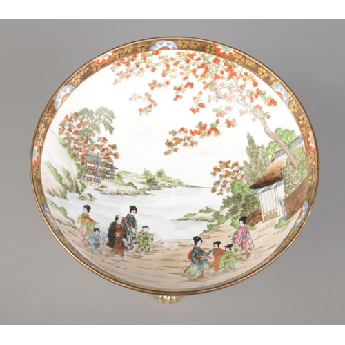 37 - A Japanese Noritake pedestal bowl on stand. Decorated with landscape scenes and figures. Height 18.5... 