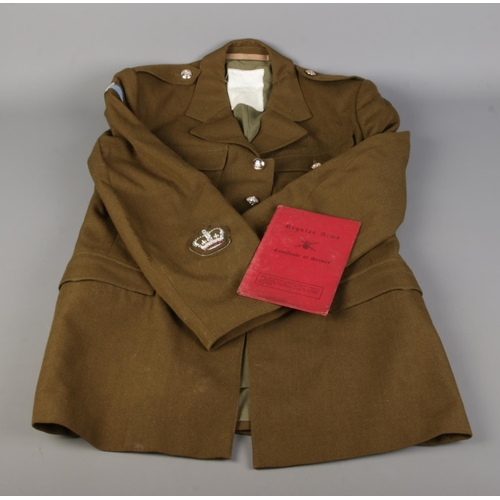 41 - A vintage Army dress jacket accompanied by a service book.