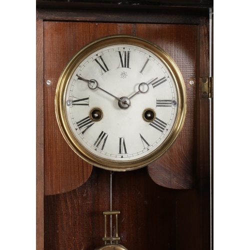 311 - A mahogany cased Junghans wall clock of small proportions, featuring carved detailing to the door an... 