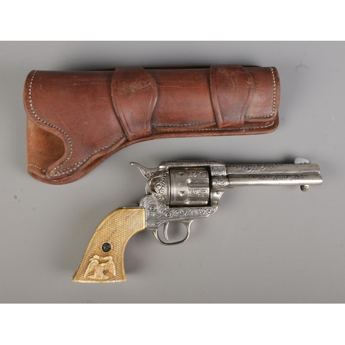 55 - A replica revolver pistol in leather holster. CANNOT POST OVERSEAS.