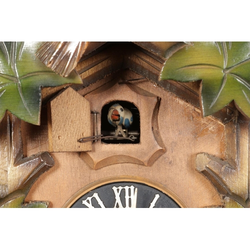 334 - A German twin weight Black Forest Cuckoo clock with Regula movement and carved bird pediment over cu... 