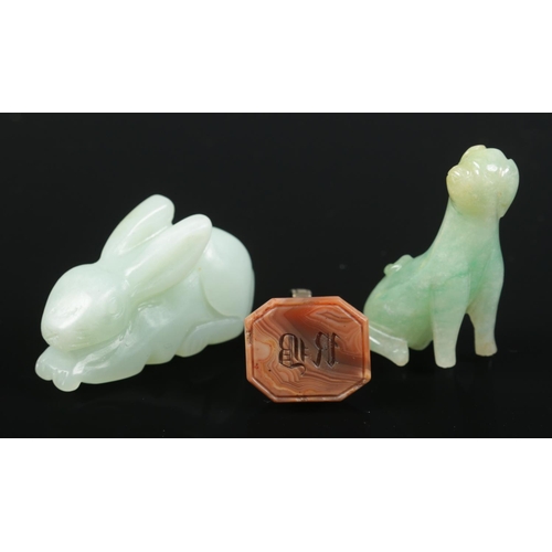 381 - A hardstone seal fob along with two jade coloured animals, rabbit and dog.