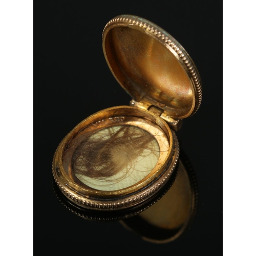 397 - A 9ct gold front and back photograph locket, along with a similar mourning pendant. Gross weight 9.0... 