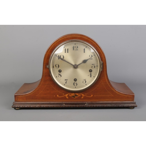 70 - A mahogany cased dome top mantle clock with stringed border and diamond inlay to the body. With silv... 