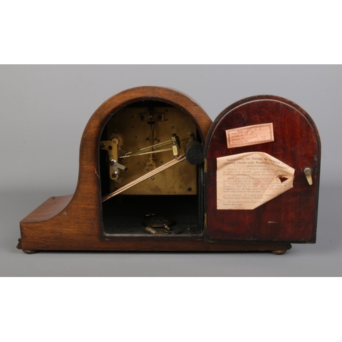 70 - A mahogany cased dome top mantle clock with stringed border and diamond inlay to the body. With silv... 