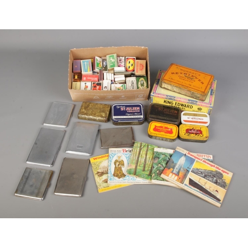 71 - A collection of vintage tobacco memorabilia and ephemera, including tins, cases, cigarette cards, ma... 