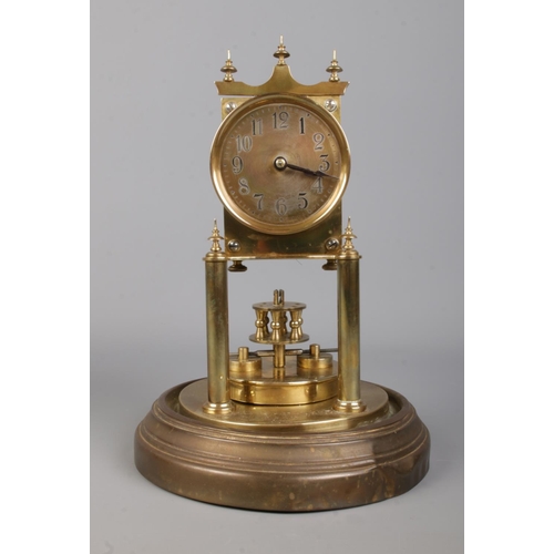 404 - A brass based anniversary mantle clock under glass dome. The movement stamped for BHA, with the face... 