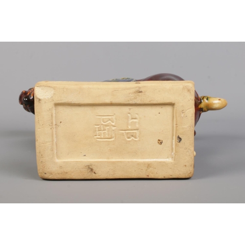 406 - A Chinese Tang Dynasty style glazed horse, raised on rectangular base. Bearing character marks to th... 