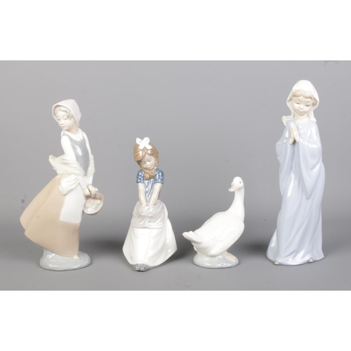 425 - Four Lladro ceramic figure groups, to include 4809 Fisher Boy, Shepherdess and 1195 Eskimo.