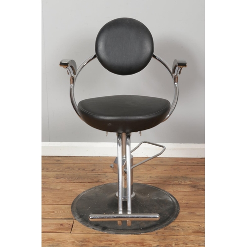 464 - A vintage chromed barbers chair, with foot pedal, black seat and headrest and painted wooden arms. O... 