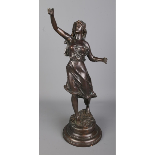 99 - After Rousseau bronze figure depicting young woman with raised hand. Signed to base. Approx. height ... 