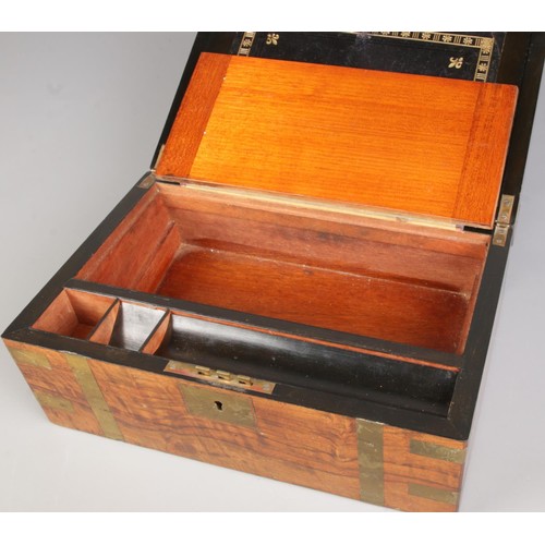 161 - A Victorian walnut writing slope featuring an engraved plaque on the top and brass inlay along the e... 