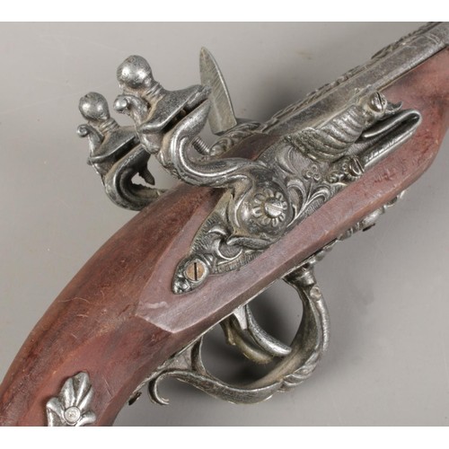 182 - Three replica metal Flintlocks, length 25cm/28cm/29cm respectively. CANOT POST OVERSEAS