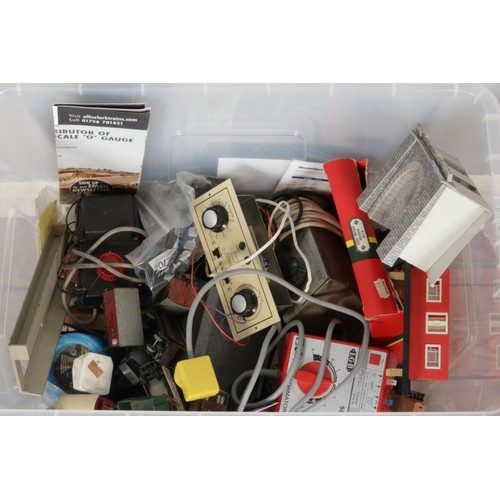 257 - A large box containing model railway parts, accessories, train carriages, power controllers, handboo... 