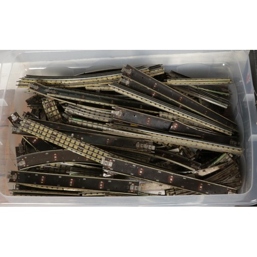 260 - Two boxes of railway modelling metal tracks, power units and other railway buildings etc.