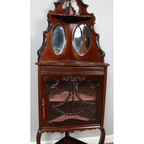 468 - A Victorian mahogany glazed floor standing corner cabinet with mirror backed shelves.