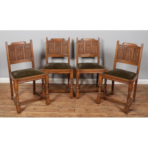 482 - A set of four oak carved gothic panel back dining chairs