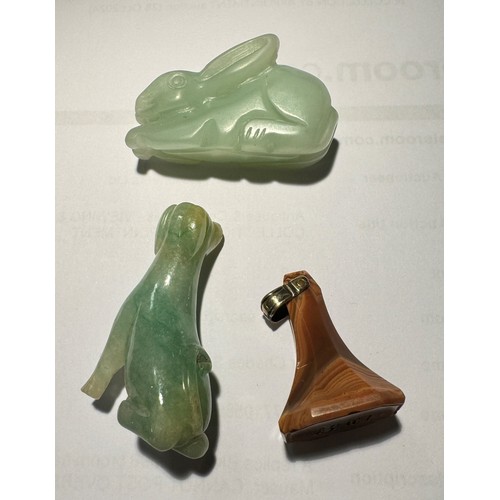 381 - A hardstone seal fob along with two jade coloured animals, rabbit and dog.