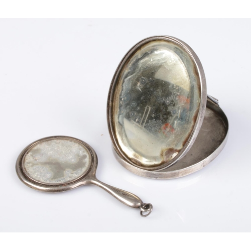 503 - An Edwardian silver folding travel mirror along with a miniature silver hand mirror. Travel mirror a... 