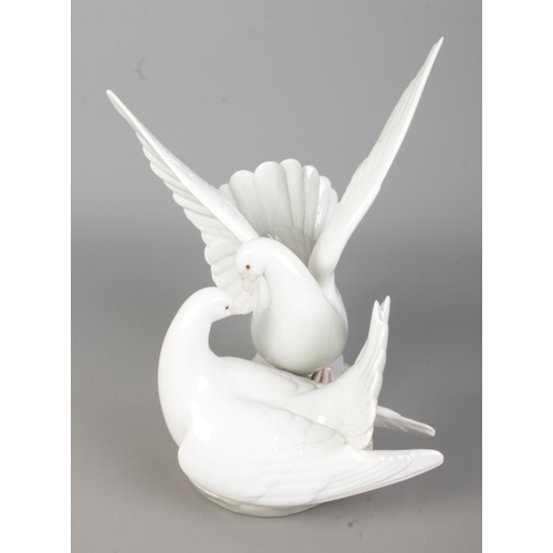 501 - A boxed Lladro ceramic figure group titled 'Love Nest' (C573C/6291) depicting a pair of white doves.... 