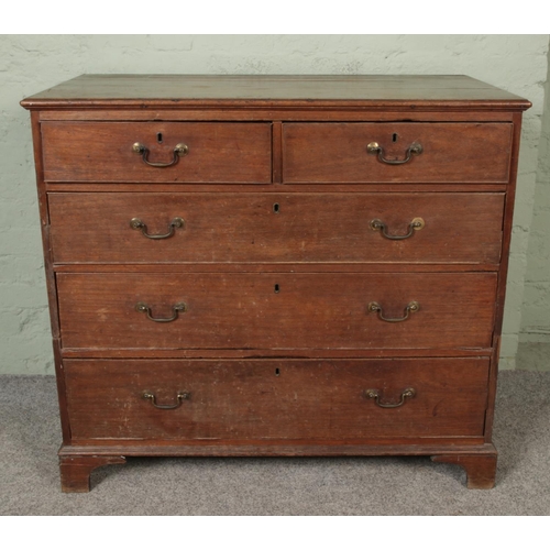 558 - A Georgian oak chest of drawers, with brass handles and bracket feet. It has three large drawers and... 