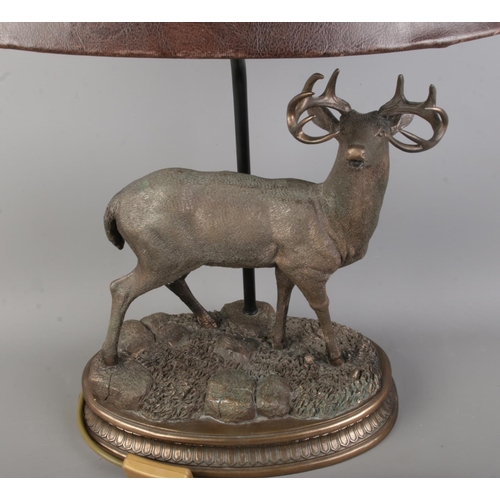 59 - A vintage Stag table lamp, with leather effect shade, bronze style finish with carved details.