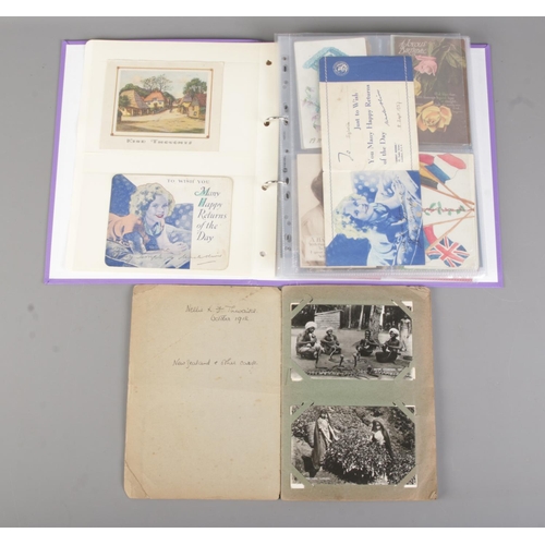 64 - Two albums containing early 20th century postcards and greetings cards to include international exam... 